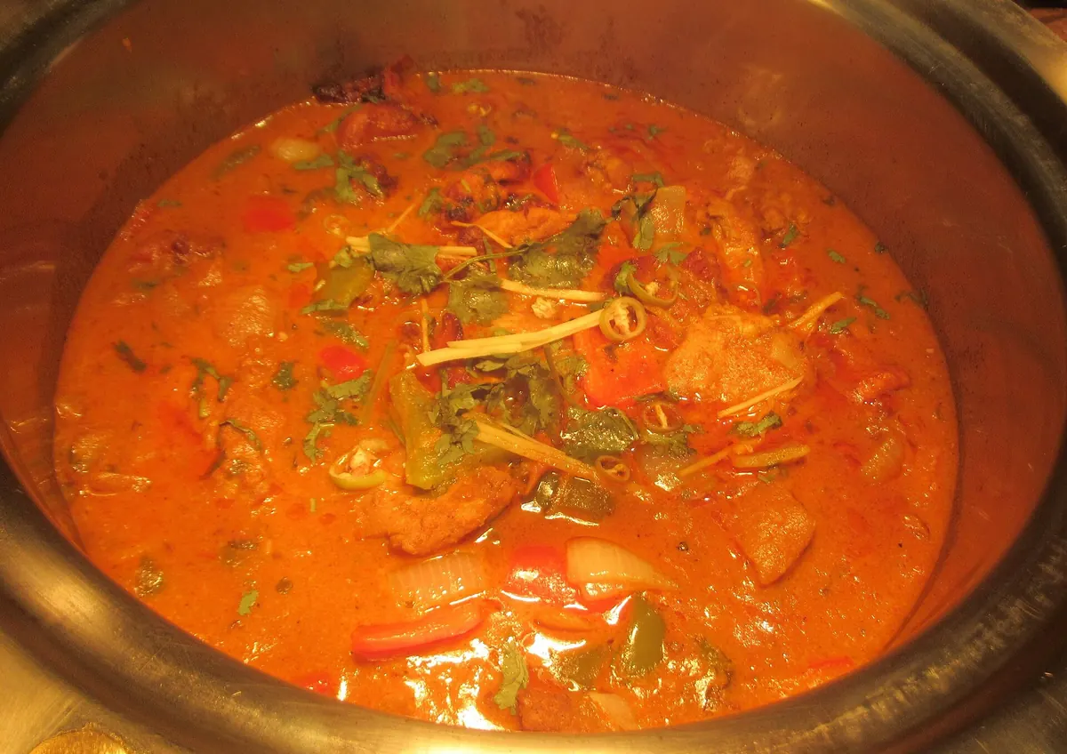 A chicken karahi, a curry served in a round metal pot
